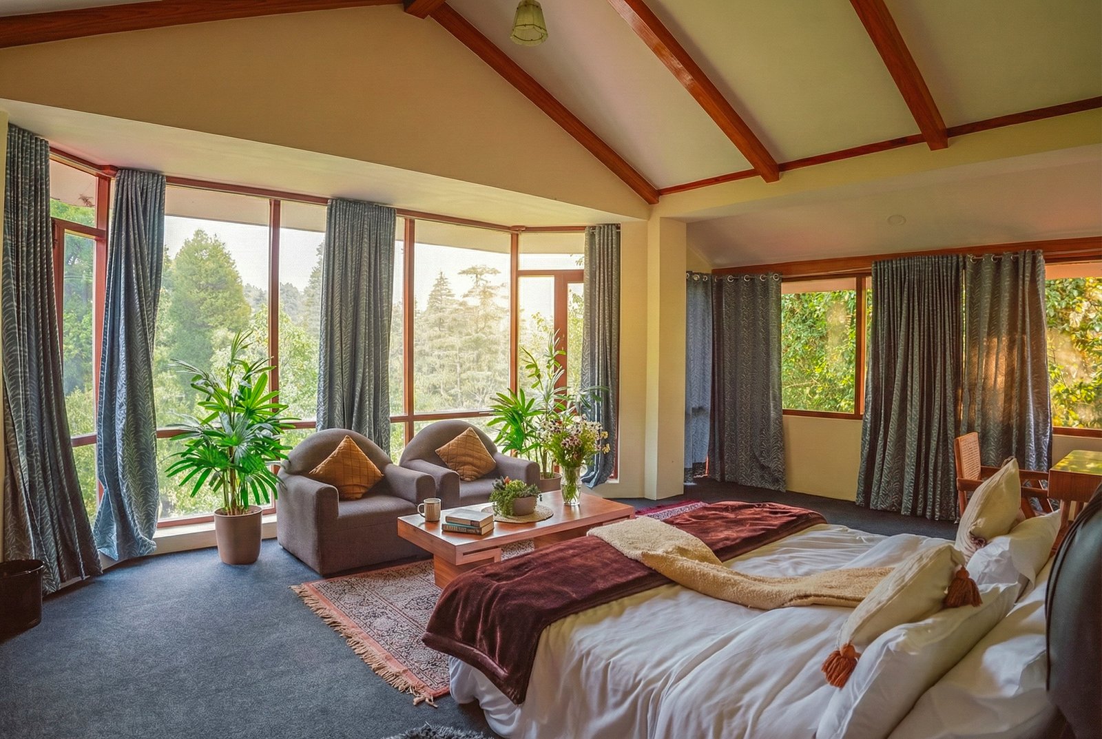 Cozy second bedroom with warm wooden interiors, soft lighting, and forest views at Forestbound luxury villa in Manali